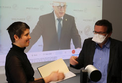 Max-Planck-Präsident Martin Stratmann (im Hintergrund) zeichnete Viola Priesemann während der Sitzung des Wissenschaftlichen Rates mit dem Communitas-Preis der MPG aus. Eberhard Bodenschatz überreichte stellvertretend die Urkunde.